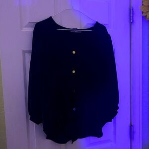 Black top with tie at the bottom and gold buttons down the front